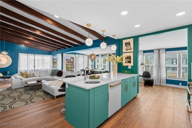 360 Bayland Rd, Fort Myers Beach, FL 33931 - kitchen featuring lofted ceiling with beams, light countertops, light wood-style flooring, dishwasher, and a sink