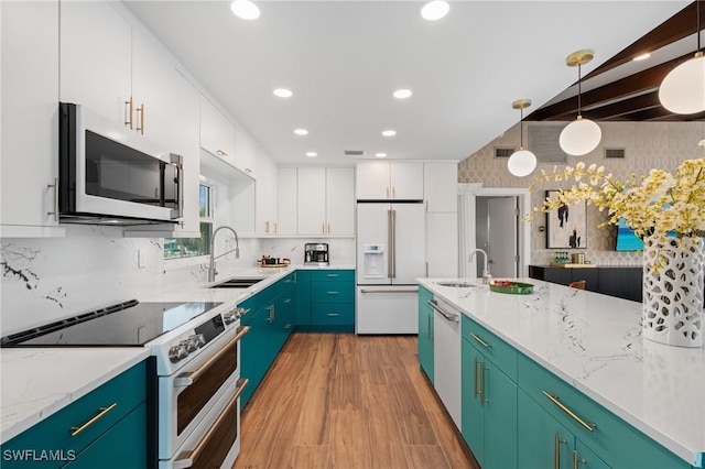 360 Bayland Rd, Fort Myers Beach, FL 33931 - kitchen featuring white appliances, white cabinets, light wood-style flooring, and a sink