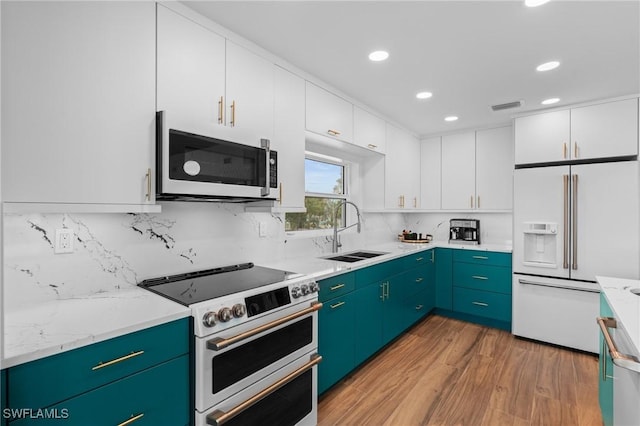 360 Bayland Rd, Fort Myers Beach, FL 33931 - kitchen with white cabinetry, white appliances, backsplash, a sink, and light wood-style flooring