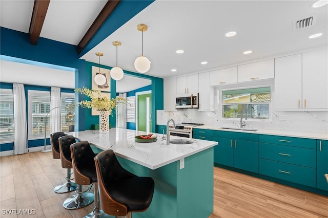 360 Bayland Rd, Fort Myers Beach, FL 33931 - kitchen featuring beam ceiling, backsplash, a sink, range with electric stovetop, and visible vents