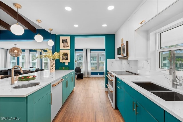 360 Bayland Rd, Fort Myers Beach, FL 33931 - kitchen with white appliances, white cabinetry, tasteful backsplash, and a sink