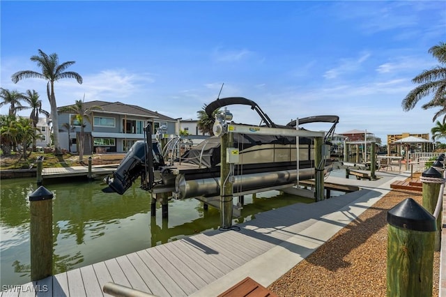 360 Bayland Rd, Fort Myers Beach, FL 33931 - view of dock featuring boat lift, a residential view, and a water view