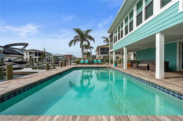 360 Bayland Rd, Fort Myers Beach, FL 33931 - pool featuring a boat dock, an outdoor living space, and a patio