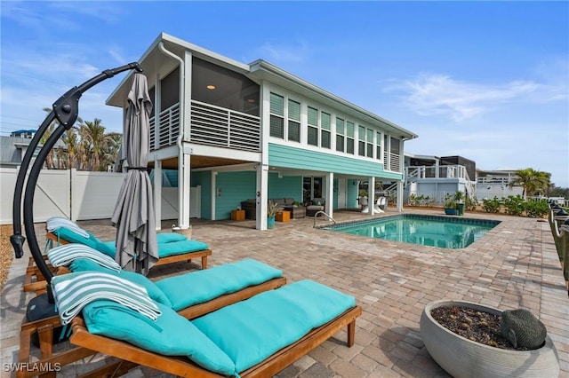 360 Bayland Rd, Fort Myers Beach, FL 33931 - back of house featuring fence, a sunroom, and a patio area