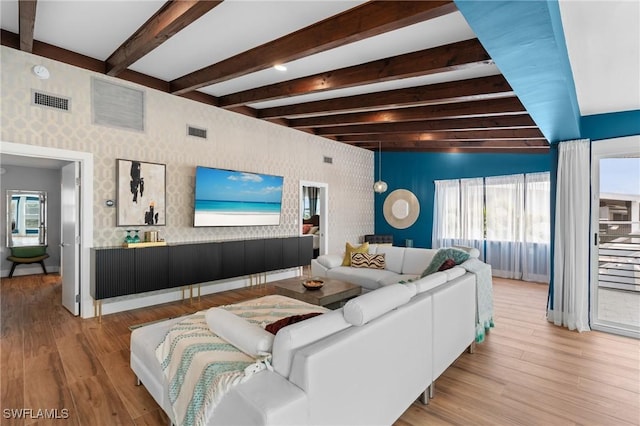360 Bayland Rd, Fort Myers Beach, FL 33931 - living room with beamed ceiling, wallpapered walls, visible vents, and wood finished floors