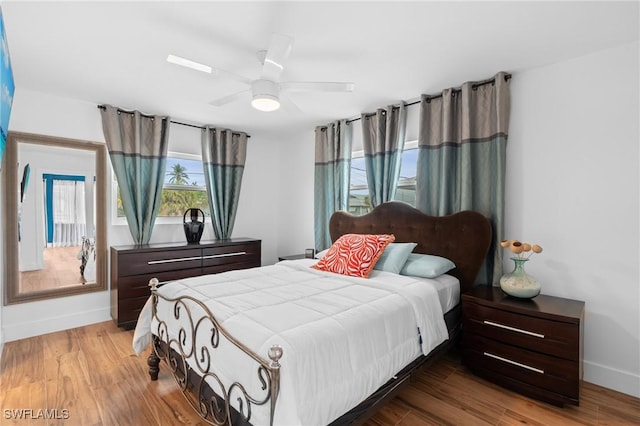 360 Bayland Rd, Fort Myers Beach, FL 33931 - bedroom with baseboards, wood finished floors, and ceiling fan
