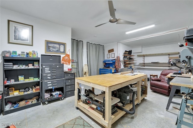 interior space with ceiling fan, a workshop area, and unfinished concrete floors