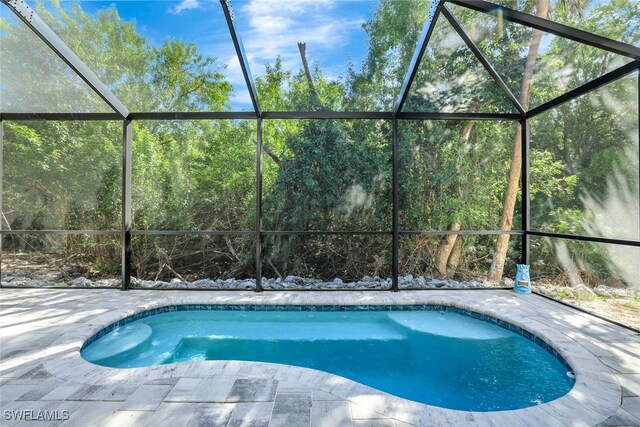view of swimming pool with a patio, a lanai, and a pool