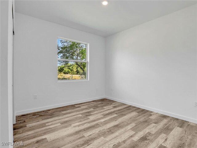 1025/1027 Meadow Rd, Lehigh Acres, FL 33973 - unfurnished room with baseboards and light wood finished floors