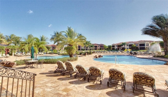 community pool with a patio area