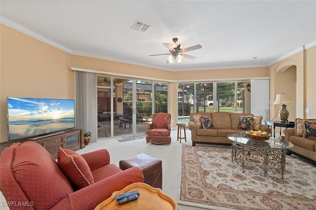 living room with visible vents, ceiling fan, and crown molding
