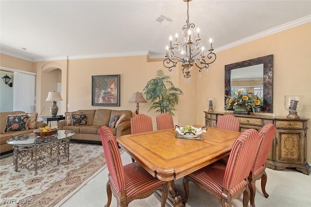 dining area featuring crown molding, visible vents, a chandelier, and light carpet