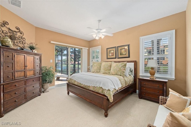 bedroom featuring light carpet, visible vents, a ceiling fan, and access to outside
