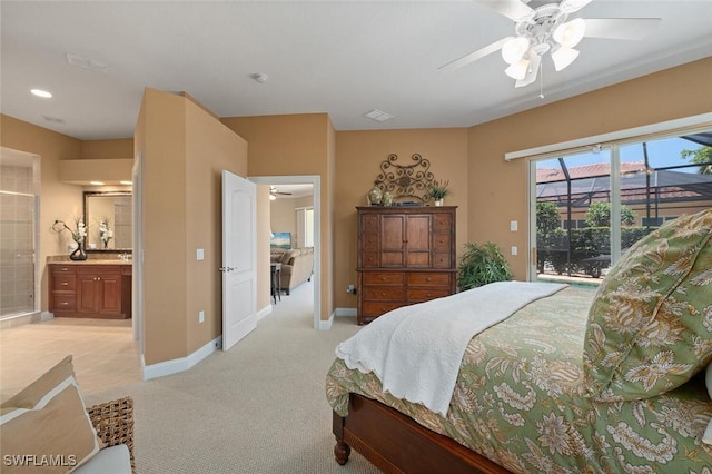 bedroom featuring a ceiling fan, baseboards, access to exterior, ensuite bathroom, and light colored carpet