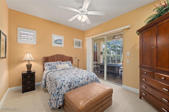 bedroom with a ceiling fan, access to exterior, light colored carpet, and baseboards
