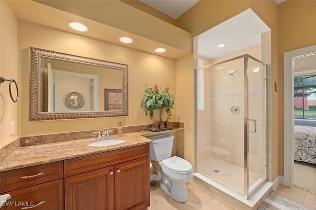bathroom with tile patterned floors, toilet, recessed lighting, a shower stall, and vanity