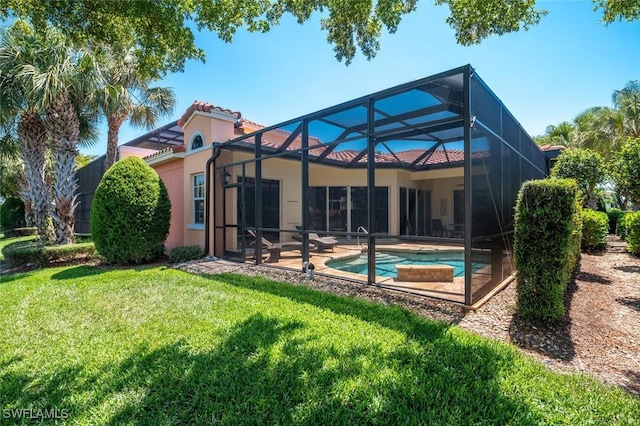 rear view of house featuring a yard, an outdoor pool, stucco siding, a tile roof, and a patio area
