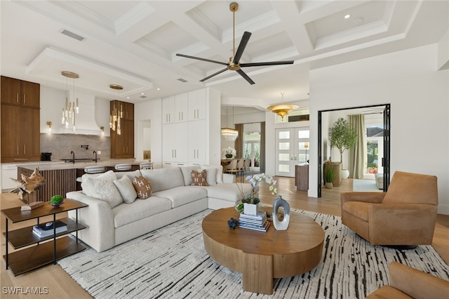 1955 Tarpon Rd, Naples, FL 34102 - living area featuring light wood-type flooring, coffered ceiling, ceiling fan, beamed ceiling, and a chandelier