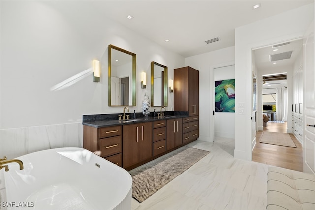 1955 Tarpon Rd, Naples, FL 34102 - full bath featuring vanity, a soaking tub, and marble look tiles