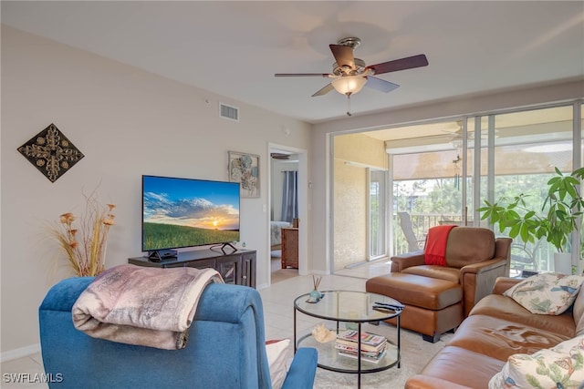 tiled living room featuring baseboards, visible vents, and a ceiling fan