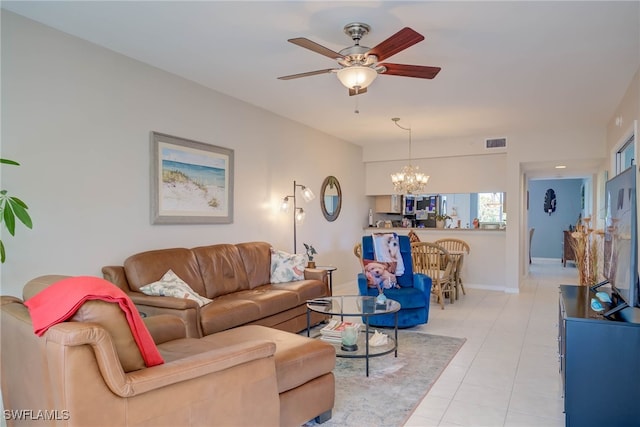 living area with light tile patterned floors, ceiling fan with notable chandelier, baseboards, and visible vents