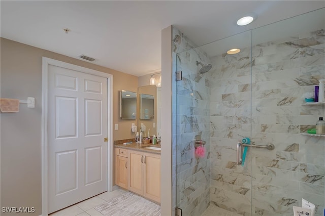 bathroom featuring tile patterned flooring, vanity, a shower stall, and visible vents
