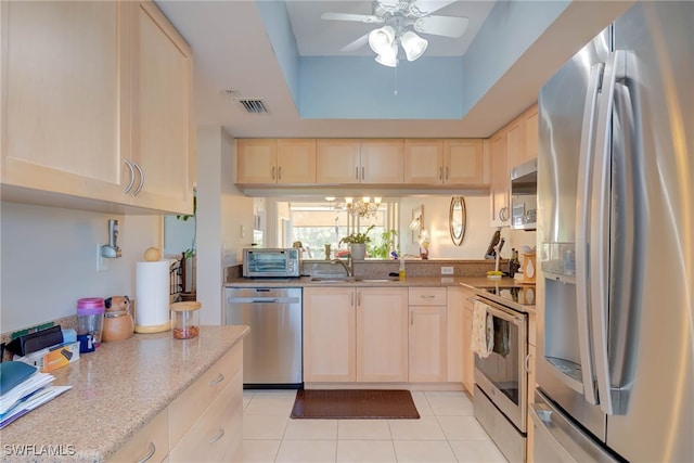 kitchen featuring ceiling fan with notable chandelier, visible vents, light brown cabinetry, and appliances with stainless steel finishes