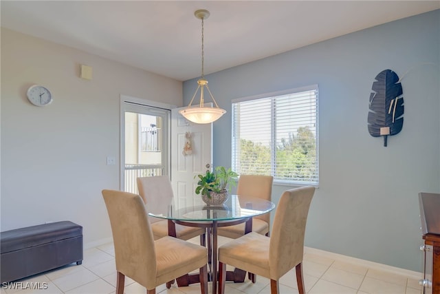 dining room with light tile patterned floors and baseboards
