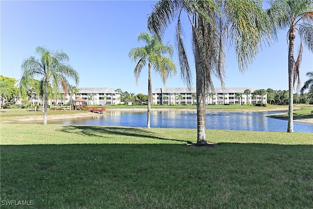 view of community with a water view and a yard
