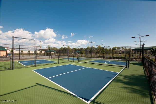 view of tennis court featuring fence