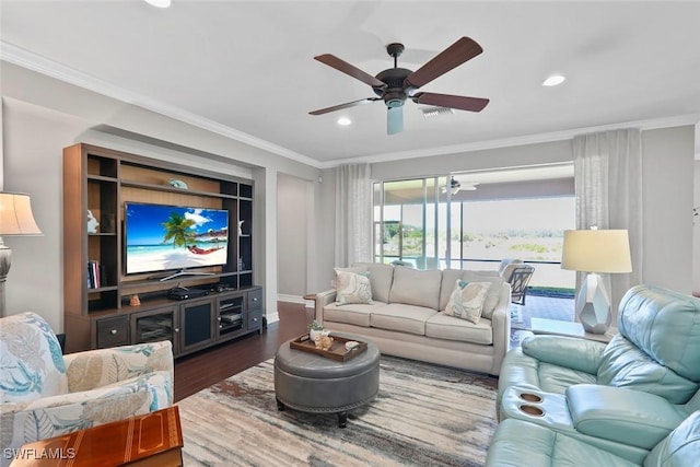 living room with a ceiling fan, crown molding, wood finished floors, visible vents, and recessed lighting