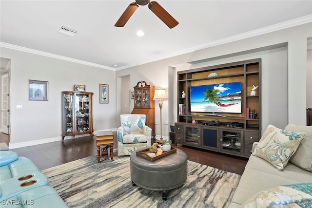 living area with wood finished floors, visible vents, a ceiling fan, crown molding, and baseboards