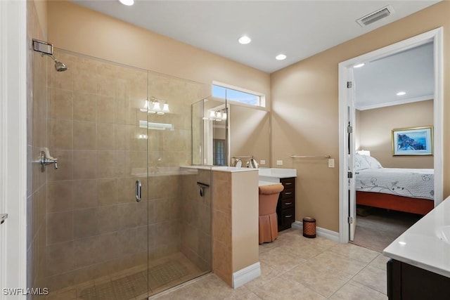 ensuite bathroom with a shower stall, vanity, visible vents, and recessed lighting