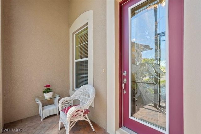 view of exterior entry featuring stucco siding