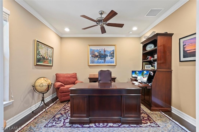 office space featuring baseboards, visible vents, ceiling fan, and crown molding