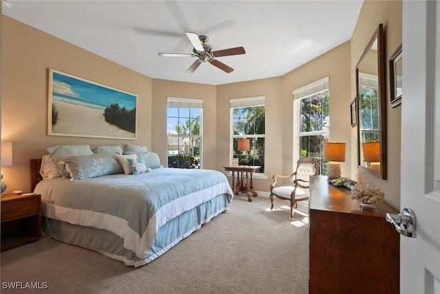 carpeted bedroom featuring baseboards and ceiling fan
