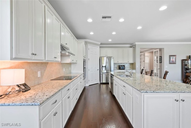 kitchen with recessed lighting, under cabinet range hood, visible vents, ornamental molding, and appliances with stainless steel finishes