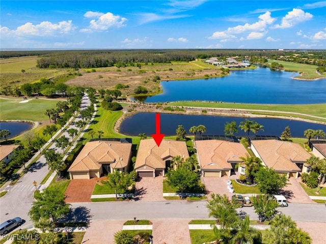 bird's eye view with view of golf course, a water view, and a residential view