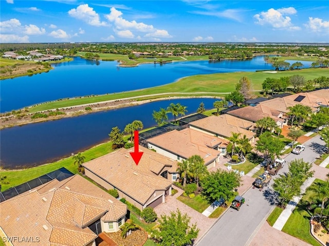 aerial view with golf course view, a water view, and a residential view