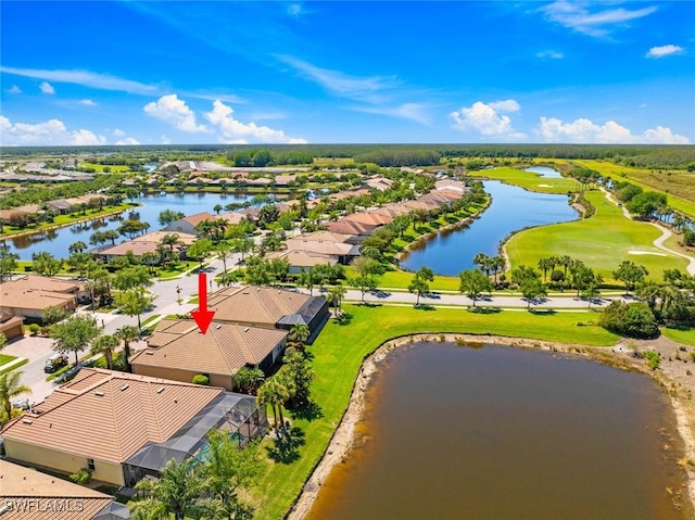 drone / aerial view featuring a residential view, golf course view, and a water view