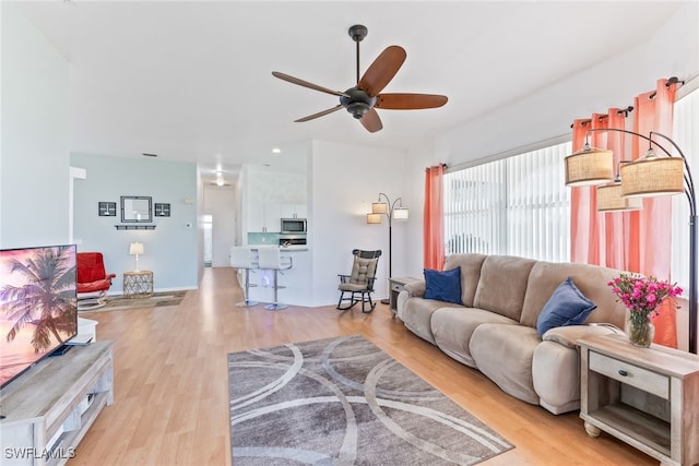 3895 Sabal Springs Blvd, North Fort Myers, FL 33917 - living area featuring light wood finished floors and a ceiling fan