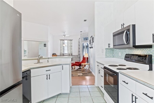 3895 Sabal Springs Blvd, North Fort Myers, FL 33917 - kitchen with stainless steel microwave, light countertops, black dishwasher, range with electric stovetop, and a sink