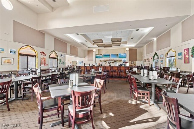 3895 Sabal Springs Blvd, North Fort Myers, FL 33917 - dining area featuring a raised ceiling, a high ceiling, visible vents, and carpet floors