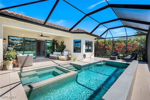 4318 Aurora St, Naples, FL 34119 - view of swimming pool featuring a patio area, a ceiling fan, a pool with connected hot tub, and glass enclosure