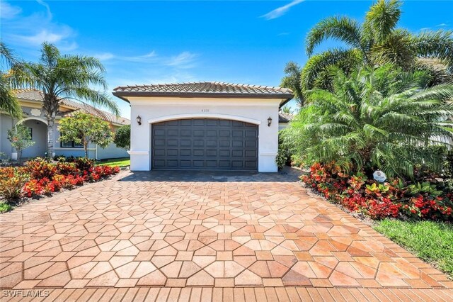 4318 Aurora St, Naples, FL 34119 - garage with decorative driveway