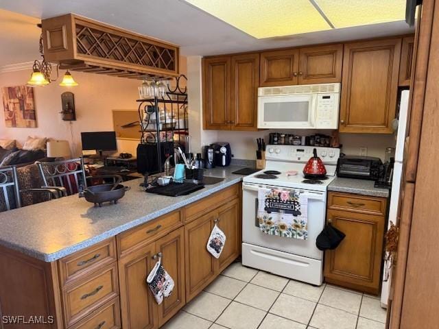 kitchen with open floor plan, a peninsula, brown cabinetry, and white appliances