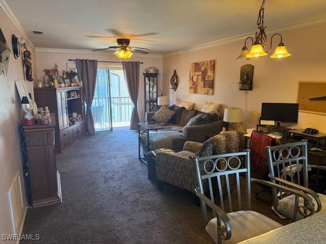 living room with carpet flooring, ceiling fan, visible vents, and ornamental molding