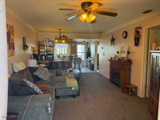 carpeted living room featuring ceiling fan, visible vents, and ornamental molding