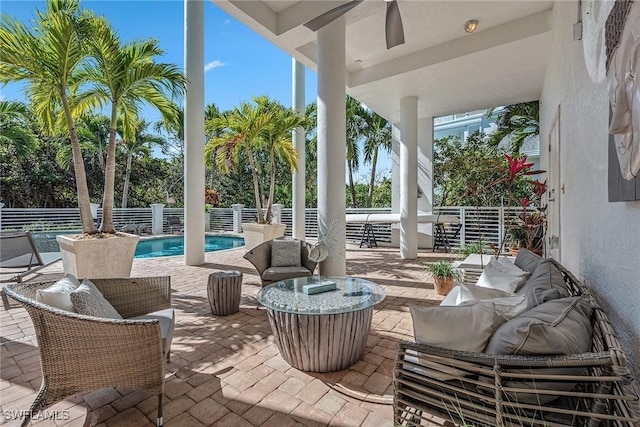 view of patio / terrace featuring an outdoor living space, fence, and a fenced in pool