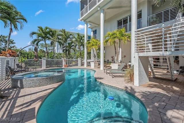 view of swimming pool with a pool with connected hot tub and a patio area